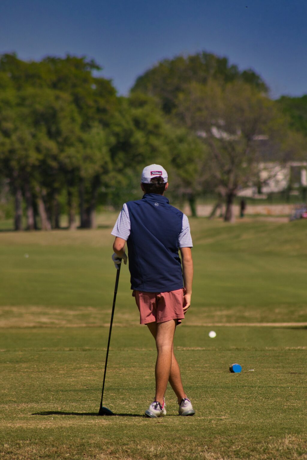 Young golfer studying the shot before playing